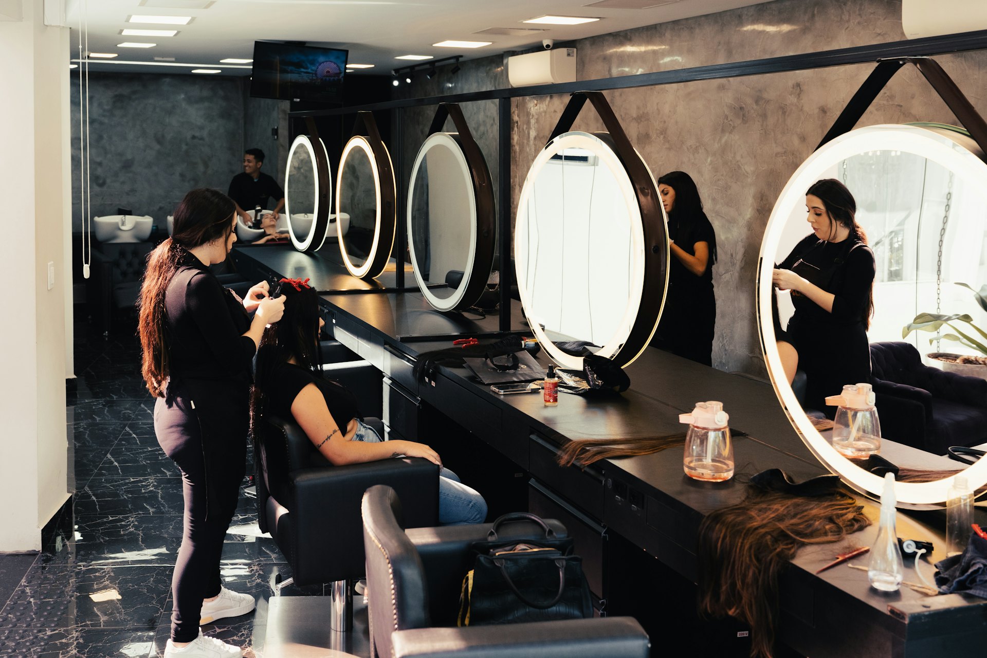 Elegant beauty studio with round mirrors and styling chairs
